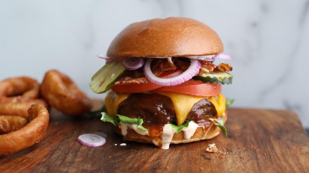 Bbq Ranch Bacon Burger* · grilled half-pound beef patty, smoked bacon, cheddar, chipotle ranch, lettuce, tomato, pickle, red onion [1050 cal] .