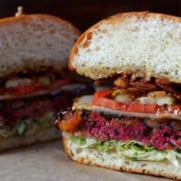 Bbq Veggie Burger · made with black beans, ancient grains, beets + vegetables, topped with roasted garlic sauce,...