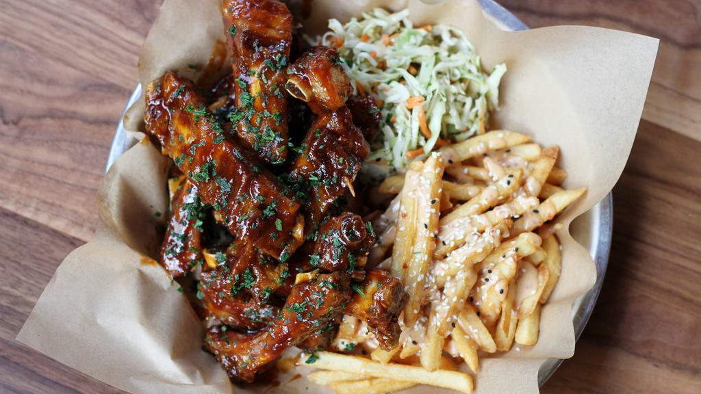 Bbq St. Louis Style Pork Ribs · tender st. louis style ribs flash-fried until crispy, brushed with our molasses BBQ sauce, peanut sesame slaw, umami fries [2270/3190 cal]