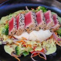 Sesame Crusted Ahi Tuna* · seared medium-rare sashimi grade yellowfin tuna, cauliflower mash, seasonal vegetables, coco...