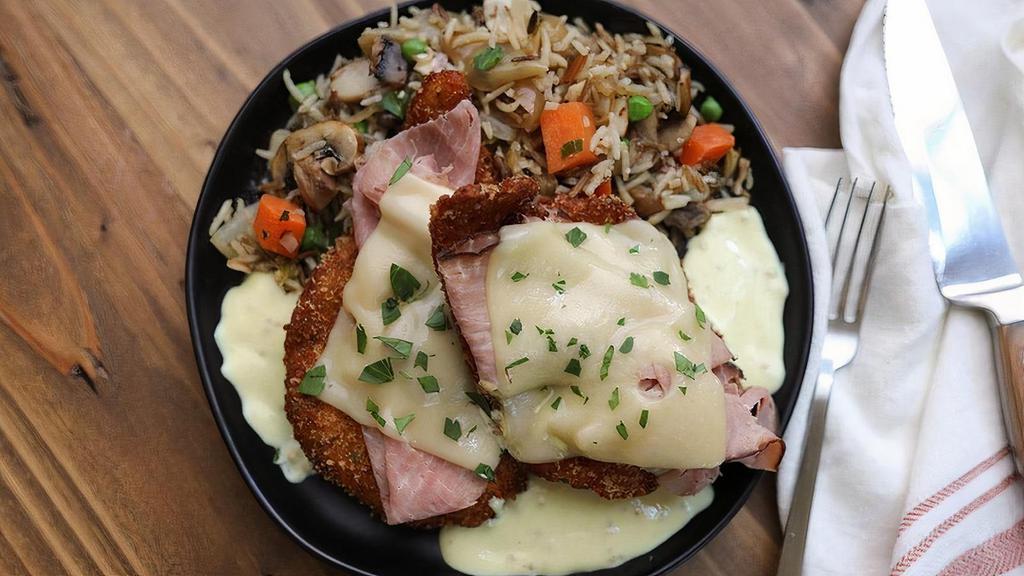 Creamy Dijon Chicken · hand-breaded chicken breasts, topped with shaved beeler’s ranch smoked ham, melted swiss cheese + whole grain mustard cream sauce, served with almond + mushroom red lake nation wild rice pilaf