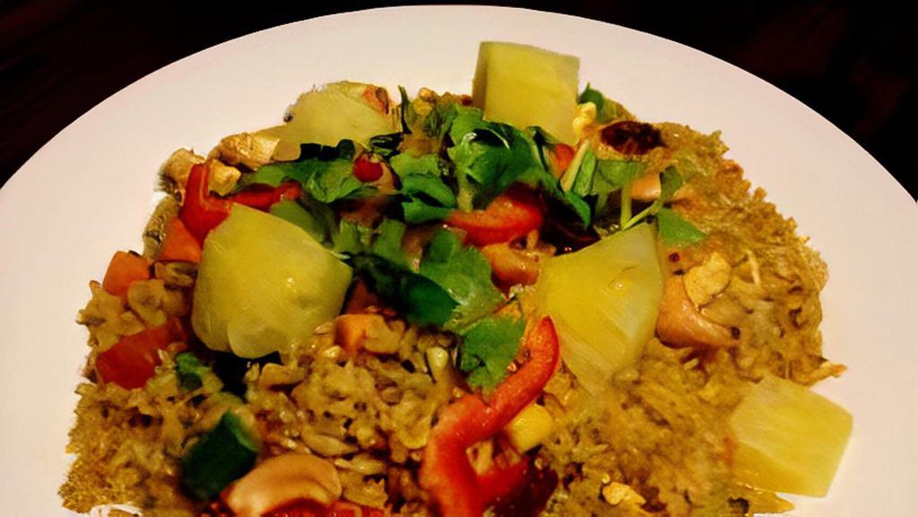 Pineapple Fried Rice Lunch · Pan fried rice with choice of meat, egg, onion, carrot, tomato, garlic, pineapple, raisin, curry powder, cashew nut and cilantro.