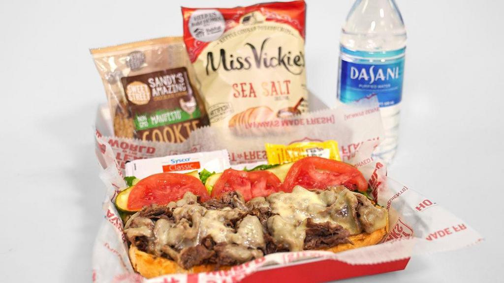 Steak Cheesesteak Boxed Meal · Charleys Steak Cheesesteak Boxed Meal includes a steak cheesesteak (grilled steak, melted provolone cheese, mushrooms, onions, and green peppers). Lettuce, tomato, mayonnaise, and mustard packets are provided on the side. . Consider adding Miss Vickie's Chips, Dasani bottled water, and a Chocolate Chunk Cookie to complete your meal..