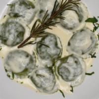 Ravioli · Homemade spinach ravioli, filled with wild mushrooms and ricotta, fondue truffle sauce