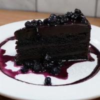 Cioccolato Cake · Chocolate layer cake filled with a rich chocolate cream, chocolate ganache, chocolate flakes