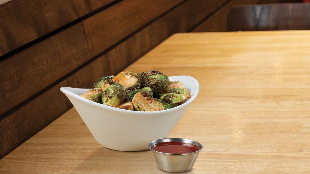 Sweet Sriracha Brussels Sprouts · fried brussels sprouts tossed in a sweet sriracha sauce