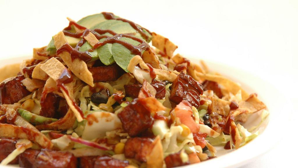 Chopped Cabbage Salad · Chopped cabbage, BBQ chicken or BBQ veggie salami, cucumber, black beans, yellow corn, avocados, tomatoes, onions, and fried tortilla.