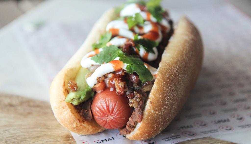 Dirty Dog · 100% Angus Beef topped with bacon, caramelized onions, pico de gallo, Tapatio ketchup, mayo, jalapeños & cilantro on a brioche bun