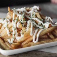 Truffle Fries · Crispy fries topped with parmesan cheese,  parsley flakes and truffle aioli sauce.