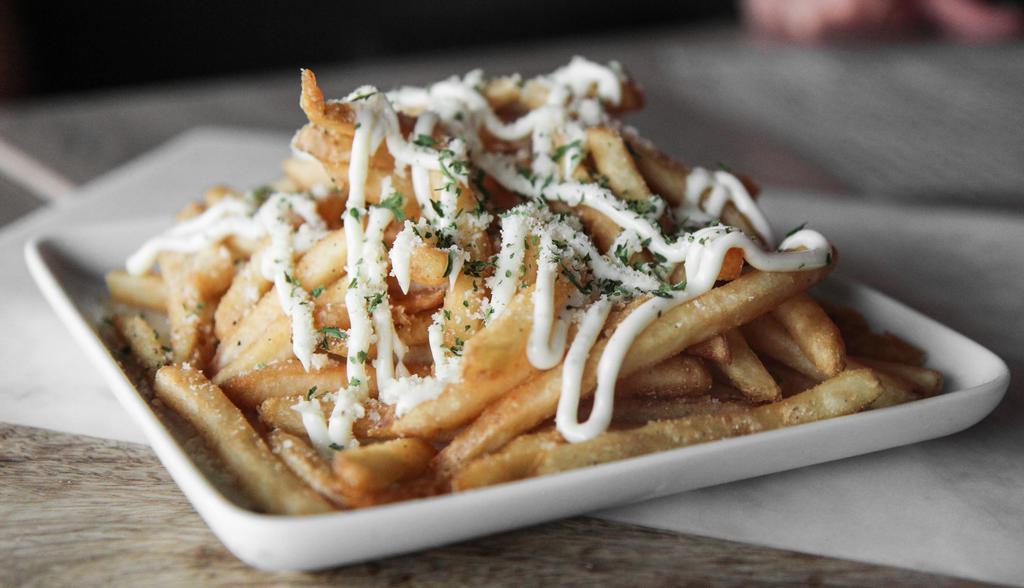 Truffle Fries · Crispy fries topped with parmesan cheese,  parsley flakes and truffle aioli sauce.