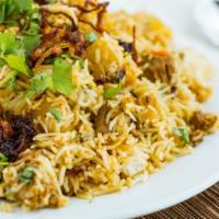 Chicken Biryani · Chicken cooked with spices and tomatoes layered in basmati rice.