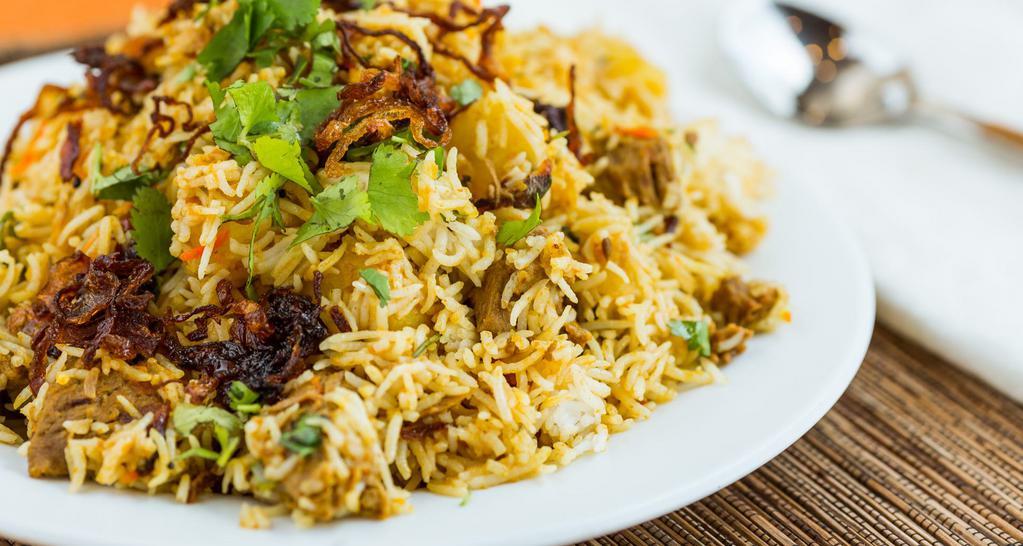 Chicken Biryani · Chicken cooked with spices and tomatoes layered in basmati rice.