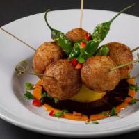 Takoyaki · Round, fried octopus skewered, topped with shishito peppers, red bell peppers and a cilantro...