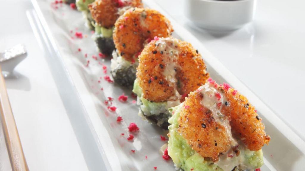 “Ra”Ckin’ Roll · Krab† and cream cheese rolled, lightly tempura battered and topped with guacamole and “RA”ckin’ shrimp; finished with creamy ginger sauce, red tempura bits and togarashi