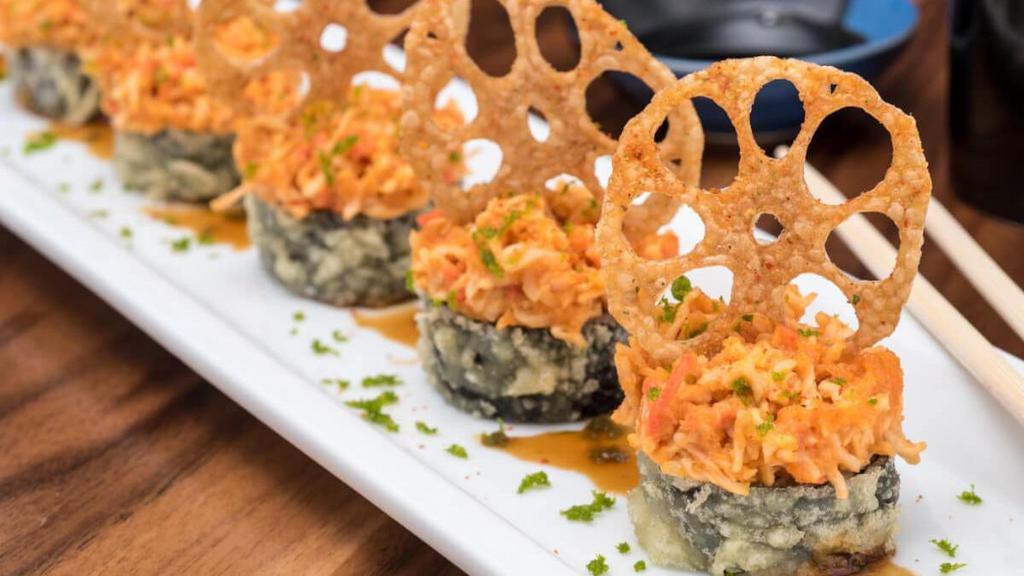 *Viva Las Vegas Roll · Krab† and cream cheese rolled in rice and seaweed, lightly tempura battered and topped with spicy tuna, krab† mix and sliced lotus root; finished with sweet eel sauce and green tempura bits