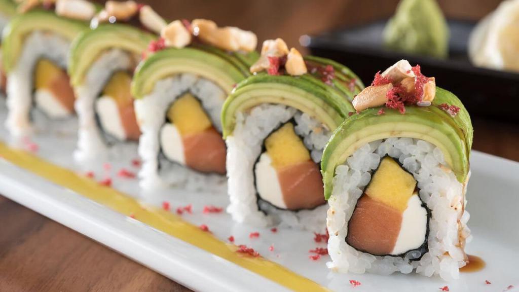 Crazy Monkey Roll* · Smoked salmon, mango and cream cheese rolled and topped with avocado, red tempura bits and sautéed cashews; drizzled with mango and sweet eel sauces