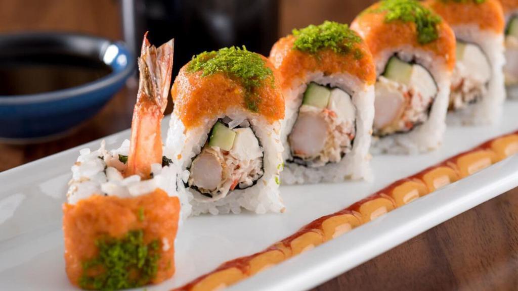 Gojira Roll* · Shrimp tempura, krab† mix, cream cheese and cucumber rolled and topped with spicy tuna and green tempura bits; served with Sriracha and spicy mayo