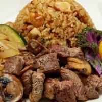 Filet Mignon · Filet mignon served with sauteed zucchini, mushrooms, and onions,“RA”ckin’ Fried Rice and ho...