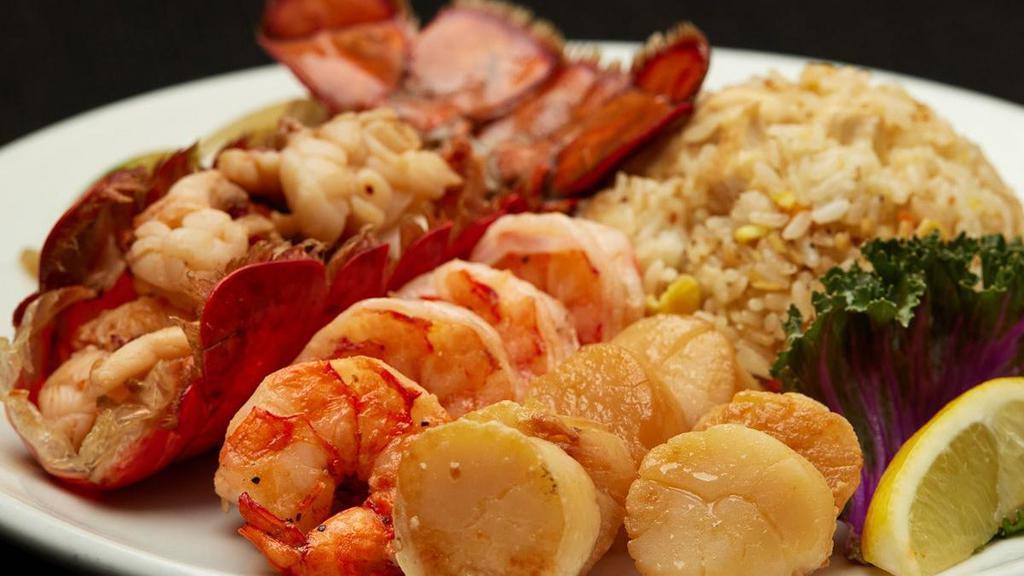 Lobster, Scallops, & Colossal Shrimp  · Grilled cold water lobster tail with grilled scallops and colossal shrimp. Served with hibachi vegetables, “RA”ckin’ Fried Rice and homemade dipping sauces.