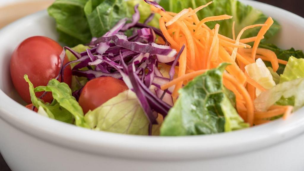 House Salad · Crisp greens, red cabbage, carrots and grape tomatoes in a tangy ginger dressing