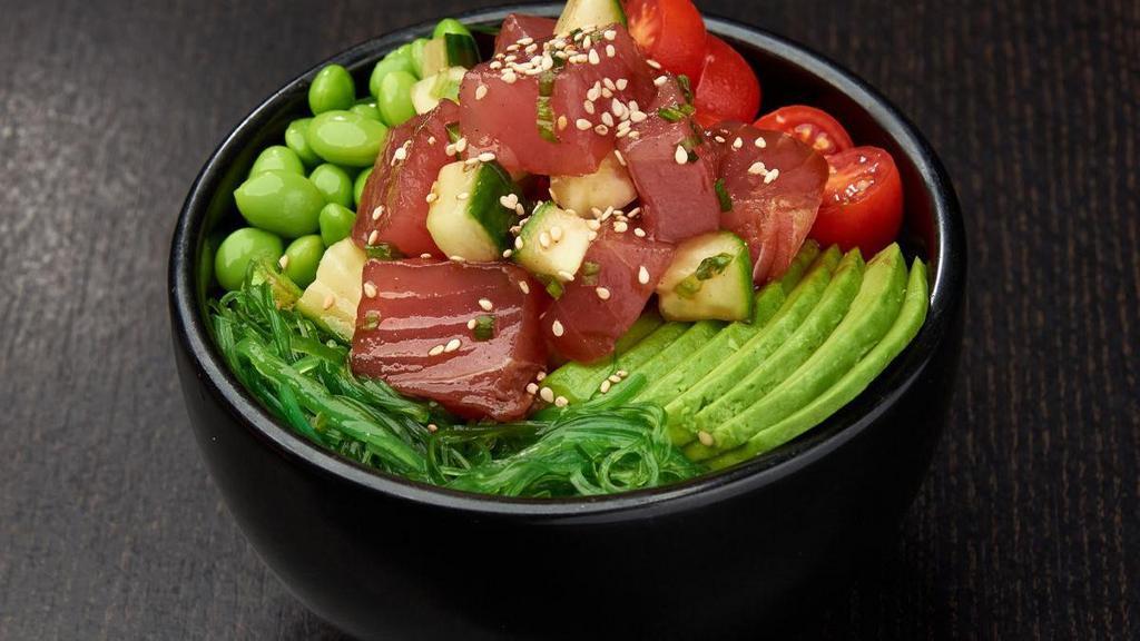Ahi Tuna Poke Bowl* · Ahi tuna, cucumber and green onions mixed in poke sauce; served with grape tomatoes, avocados, edamame and seaweed salad; topped with sesame seeds.