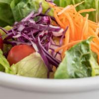 House Salad · Crisp greens, red cabbage, carrots and grape tomatoes in a tangy ginger dressing