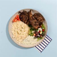 Lamb Chop Rice Platter · Grilled lamb chops served with rice, salad, pita bread, and tzatziki.
