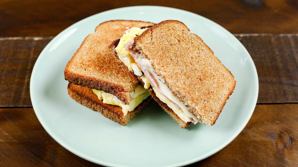 Breakfast Toast · A simple toast made with two slices of wheat bread, scrambled egg, and two slices of ham & cheese.