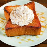 Caramel Cinnamon Bread · Brick styled bread topped with powdered sugar, whipped cream, caramel sauce, and cinnamon po...