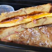 Freakin French Toast · Eggs, cheddar cheese turkey bacon all nested in our cinnamon swirl bread dipped in our golde...