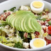 Cobb · Romaine lettuce, roasted chicken, tomato, avocado, bacon, blue cheese, hard boiled egg, and ...