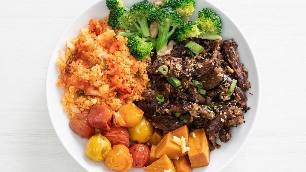 Kimchi Beef Bowl · Packed with immunity boosters: Kimchi couscous, roasted ginger yams, roasted baby tomatoes, and roasted garlic broccoli topped with marinated bulgogi beef | 900 cals.