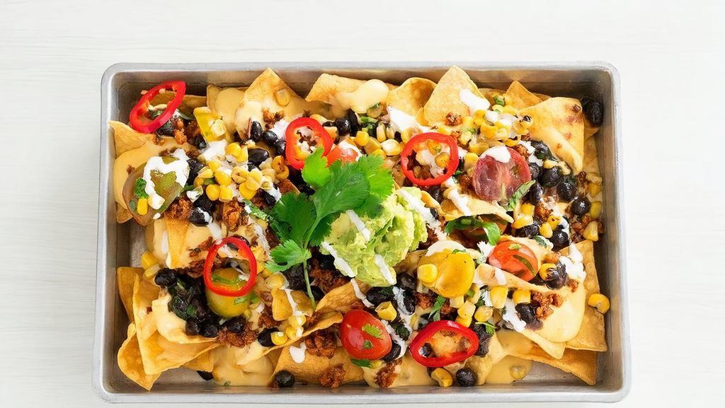 Southwestern Nachos  · Serves 2 | Corn chips, queso sauce, Tex-Mex style taco meat, ranchero beans, roasted tomato corn salsa, mashed avocado, sour cream and pickled chiles  | Sub crispy fries (+$1.60) | Gluten-friendly | 610 cals