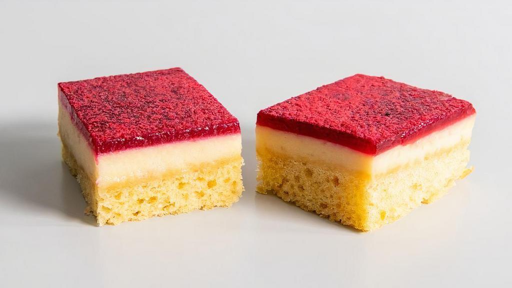Lemon Raspberry Cake · Layers of fluffy lemon cake, creamy lemon vegan cheesecake, and topped with raspberry jam