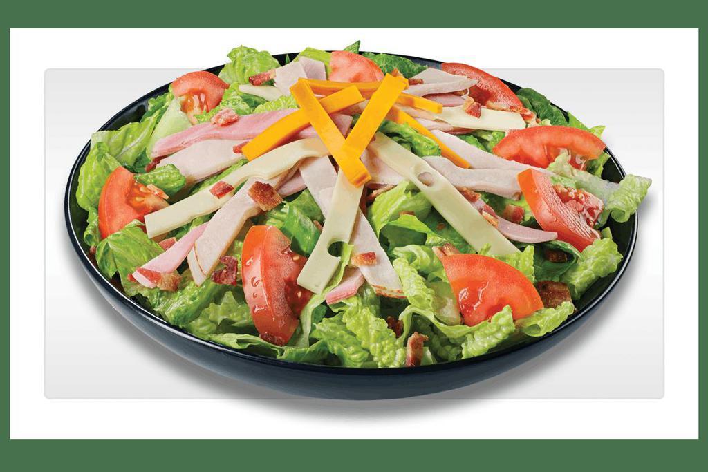 Ultimate Club · Crisp lettuce blend topped with slow-cured ham, oven-roasted turkey, Swiss, smoked cheddar, bacon and tomatoes