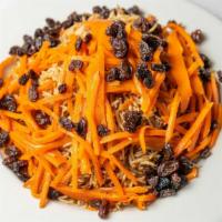 Quabili Pallaw · Lamb under a mounted of browned basmati rice, topped with carrot strips and raisins.