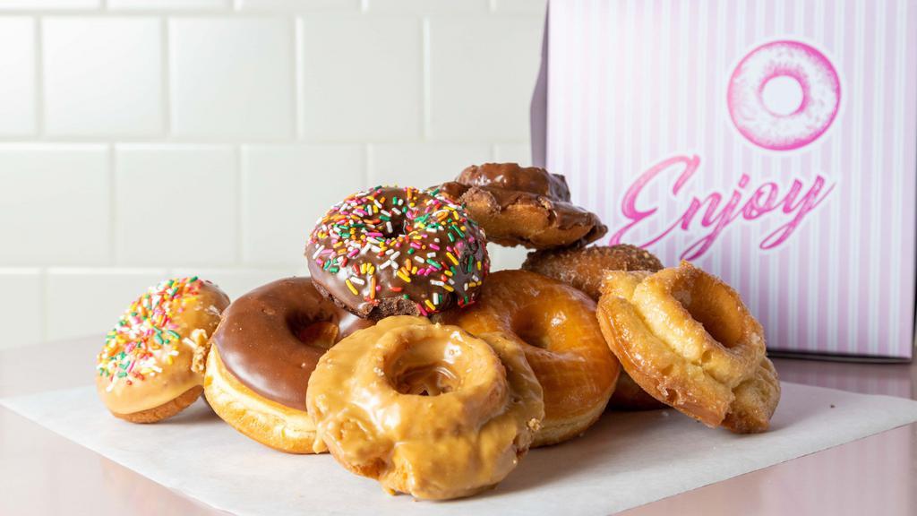 Donuts · Mix of regular raised donuts, cakes, old fashion, French crullers and a fancy donut.