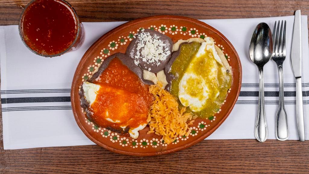 Huevos Divorciados (PF) · Two Lightly fried tortillas topped with refried beans, over easy eggs tomatillo sauce and chile de arbol sauce
