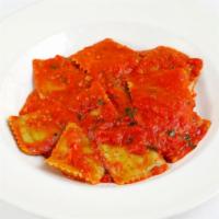 Catering Ravioli Spinaci · Homemade spinach and ricotta cheese pasta pockets, light tomato sauce with basil.
