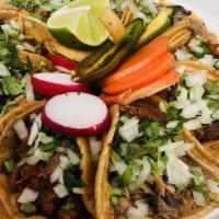 Taco (1) · Two soft shell tortillas with your choice of meat topped with onions and cilantro