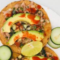 Ceviche  · 1 Tostada filled with ceviche made out of fish, cilantro, onions, tomato, cucumbers, jalapeñ...