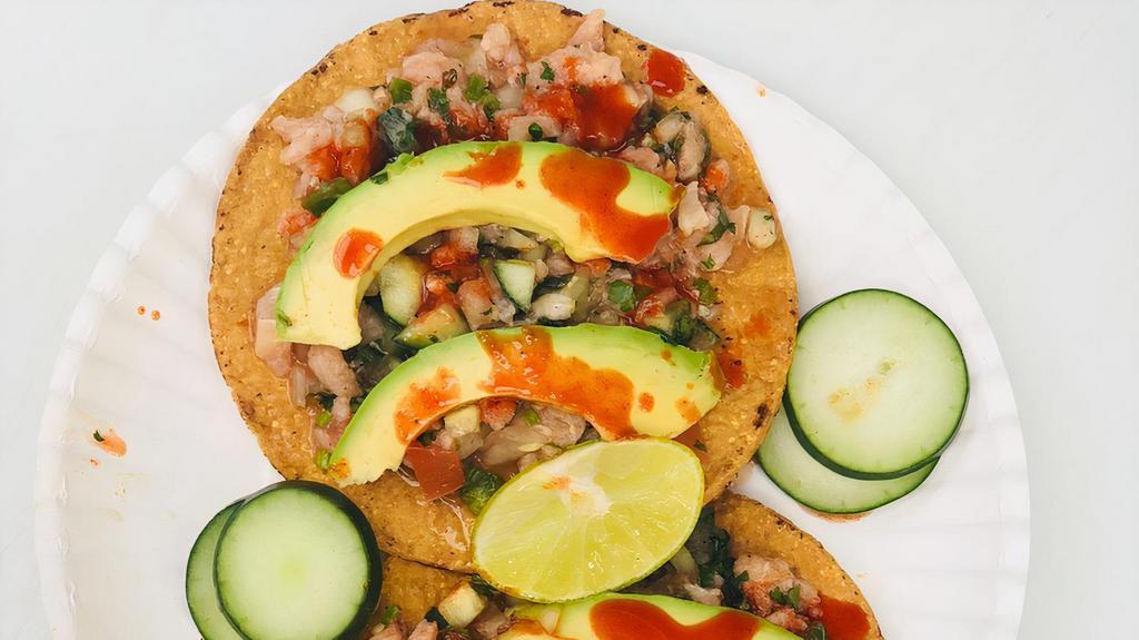 Ceviche  · 1 Tostada filled with ceviche made out of fish, cilantro, onions, tomato, cucumbers, jalapeños, and lime juice toped with fresh avocado