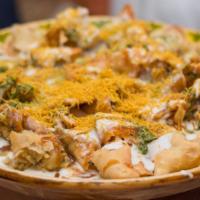 Samosa Chaat · Traditionally prepared cumin flavored potato and pea mixture, topped with a garnishing of yo...