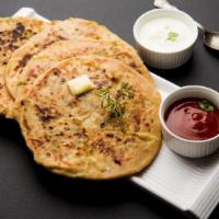 Aloo Paratha · Flakey layers of baked dough filled with potatoes.