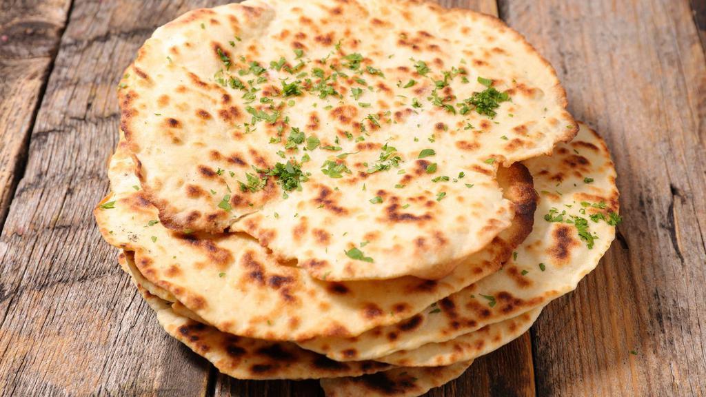 Butter Naan · Fresh baked pillow dough topped with melted butter.