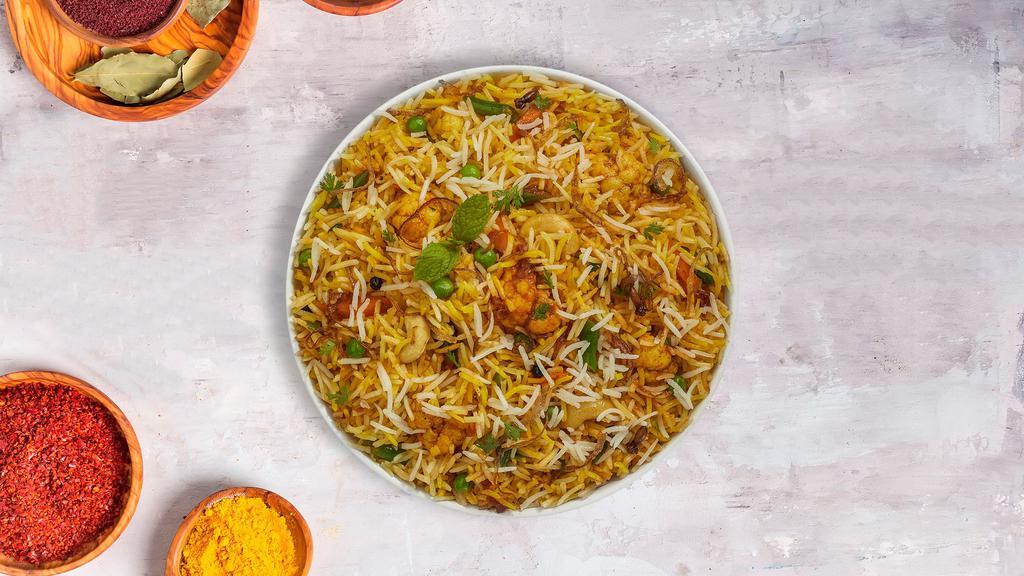 Veggie Biryani Bros. · Vegetables, Peas, Paneer and whole spices cooked with clarified butter. Basmati rice is cooked separately and layered on top of vegetables and steamed to make a flavorful dish. Served with Mirchi ka Salan and Raita.