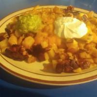 Spuds Deluxe · Our Deluxe Spuds, prepared with onions and spices are topped with cheddar cheese, guacamole,...