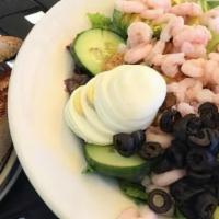 Shrimp and Avocado Salad · A tossed green salad is topped with a generous portion of bay shrimp, sliced avocado, sliced...