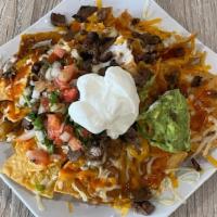 Super Nachos · With chips, mozzarella cheese, beans, red sauce, the meat of your choice, pico de gallo, gua...