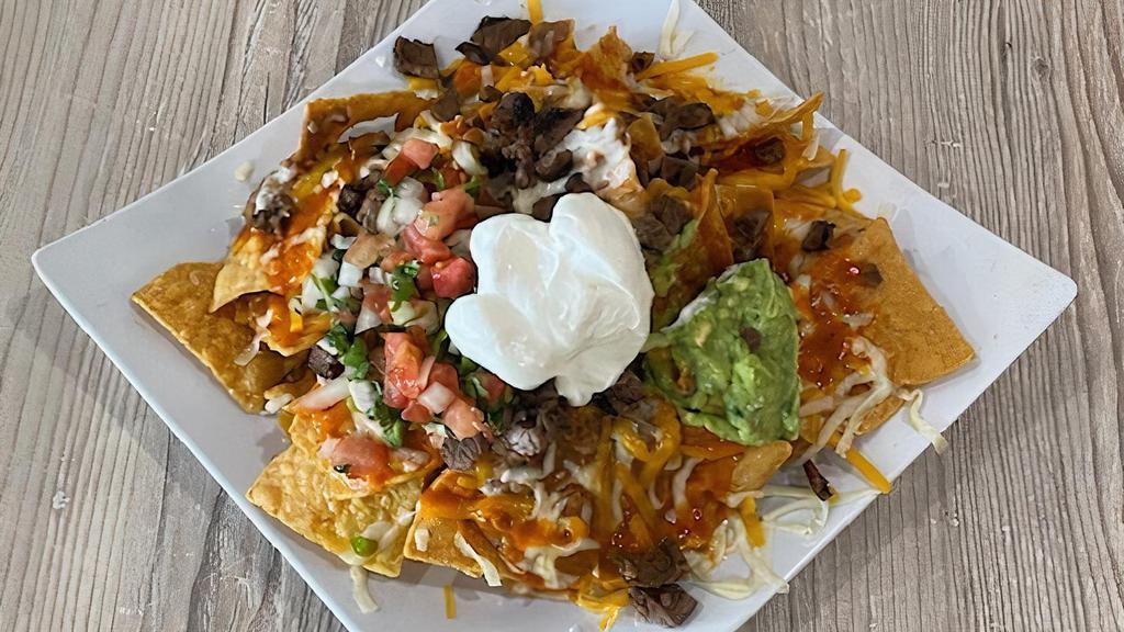 Super Nachos · With chips, mozzarella cheese, beans, red sauce, the meat of your choice, pico de gallo, guacamole, and sour cream.